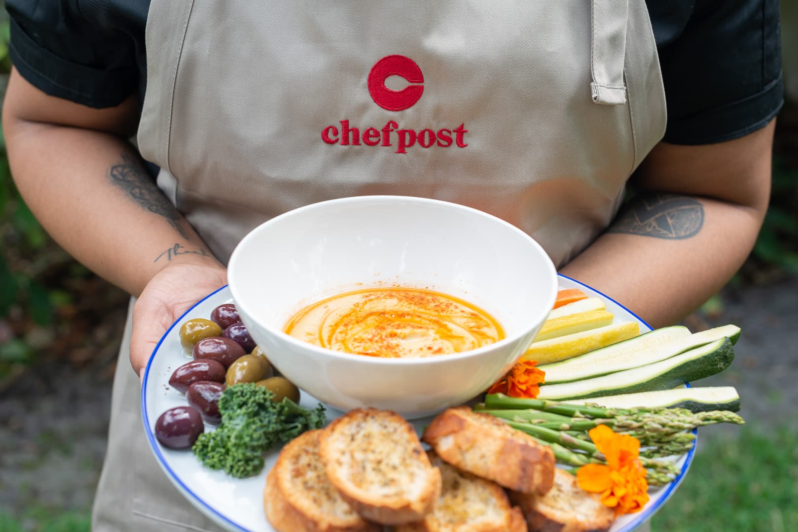 A private chef serving an outdoor al fresco meal