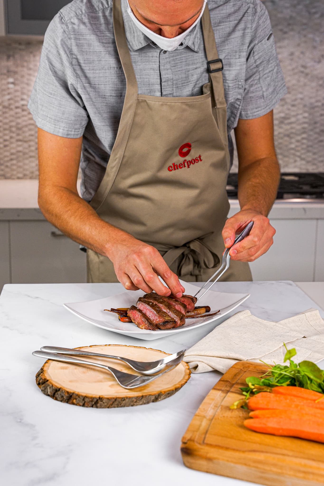A private chef slicing meat on a wood board for a dinner in Brickell