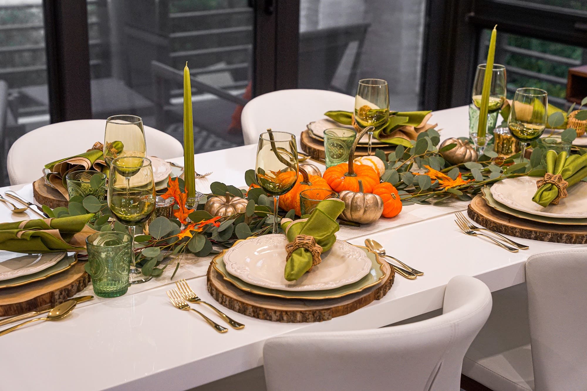 A green-toned autumn tablescape with gold accents set for a private chef dinner party in Coral Gables
