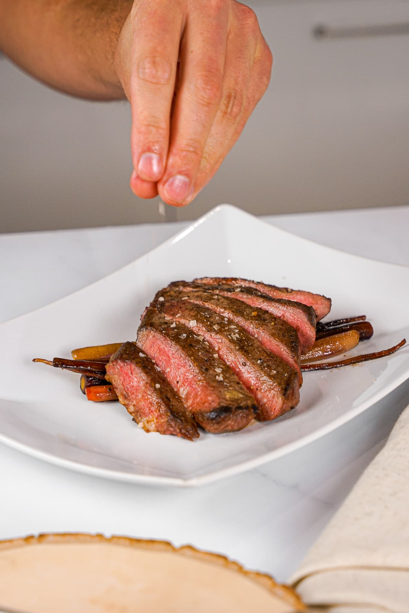 Sliced beef plated on a white plate by a private chef in Aventura