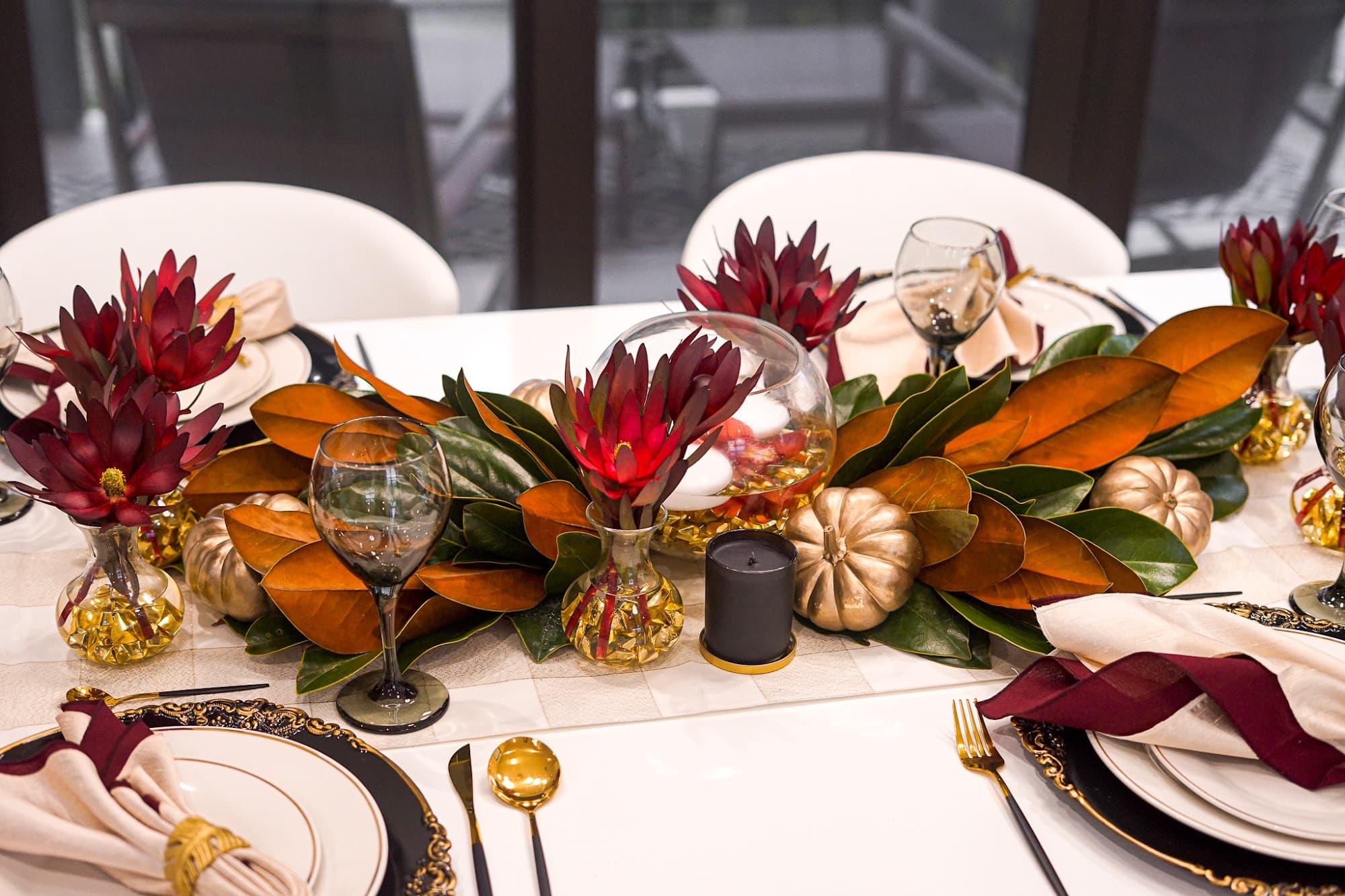 A refined Bal Harbour table setting with autumn florals and gold accents