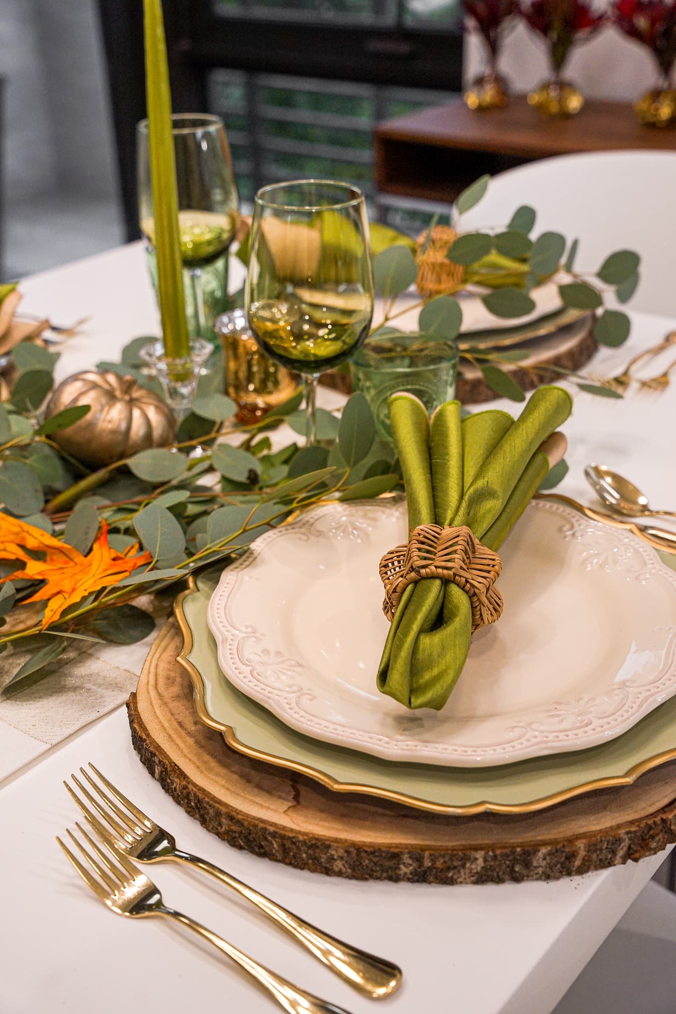 An elegant green-toned table setting with gold flatware by a private chef in Montclair