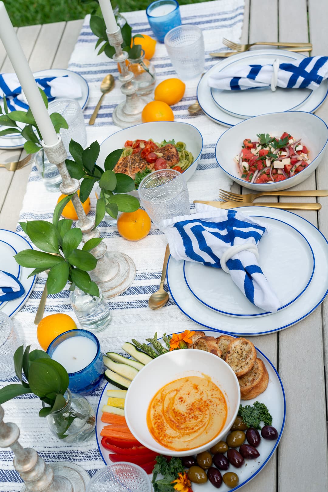 A blue-and-white al fresco table set with lemons and mezze by a private chef on Miami Beach
